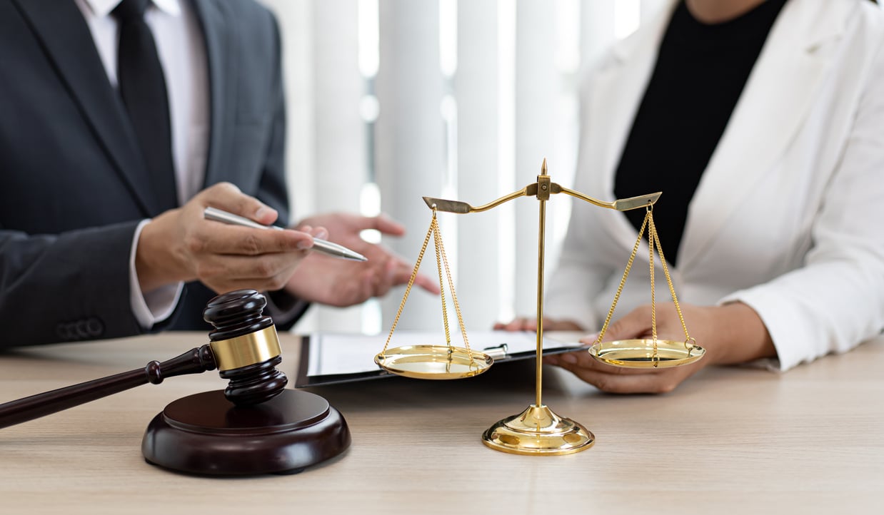 Lawyers with Judge Gavel and Justice Scales on Table